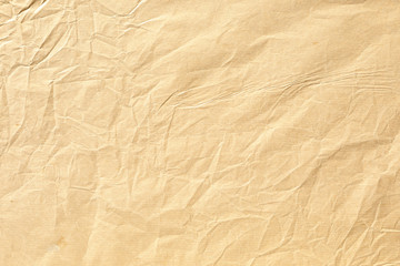 Fototapeta na wymiar Old pale yellow crumpled paper background texture