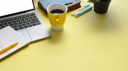 Top view image of colorful workplace that full of document, coffee cup, notebook, pen, marker pens...