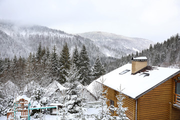 Fototapeta na wymiar Beautiful landscape with cottage on snowy winter day