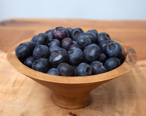 A studio photograph of a bowl of blueberries