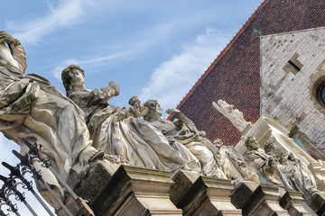 Fragment of the fence of St. Peter and Paul Church with statues of saints on the Grodka Street in the Old Town of Krakow