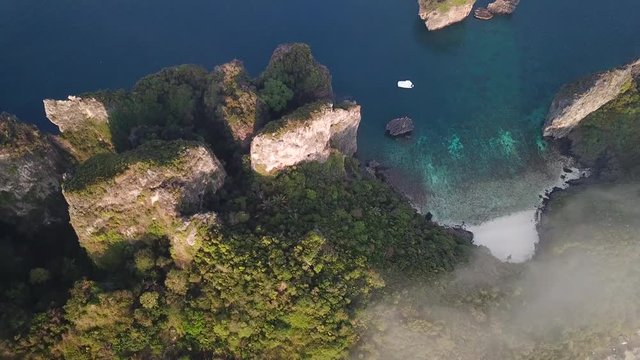 aerial footage of Nui beach with misty in the morning, Phi Phi island, Krabi. opular place for traveling in summer vacation. famous destination among tourist.
