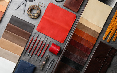 Flat lay composition with leather samples and craftsman tools on grey stone background