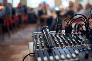 Microphone voice speaker on audio mixer machine in conference hall, seminar event or wedding...