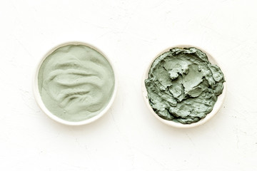 Blue cosmetic clay on white background top-down