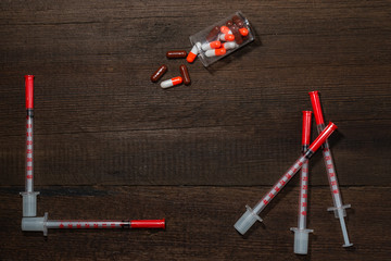 Medical syringes for insulin on a wooden background. Diabetes