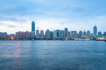 Naklejka premium Beach and beautiful city skyline at night, Qingdao, China