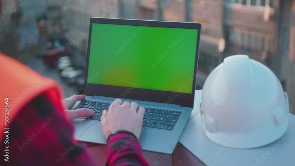 Wall mural beautiful background hands man engineer using laptop computer with green screen on balcony helmet wo