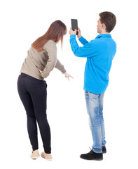 Back view of couple in sweater with mobile phone.