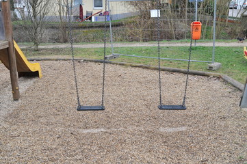 Empty swings on closed playground
