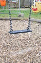 Emtpy swing on closed playground