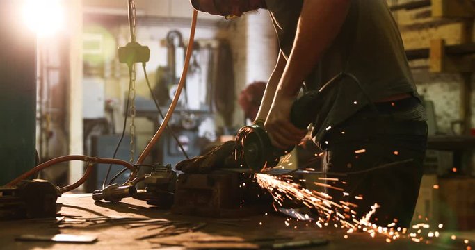 Bladesmith working with angle grinder