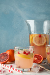 Lemonade with cranberry and lemon on wooden background, space for text