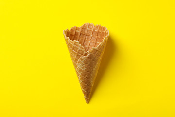 Waffle for ice cream on yellow background, space for text