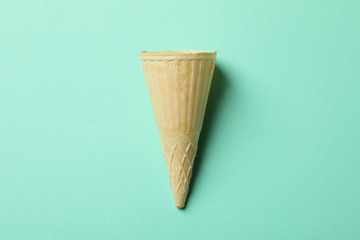 Waffle for ice cream on mint background, space for text