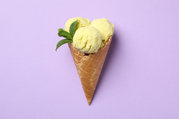 Ice cream with mint on violet background, space for text