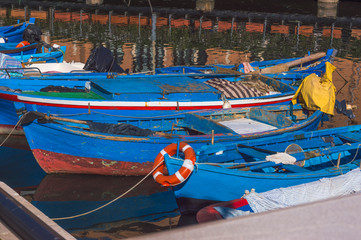 Fototapeta na wymiar Rustic boats moored in fishing harbor