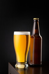 Beer glass and bottle on bar counter