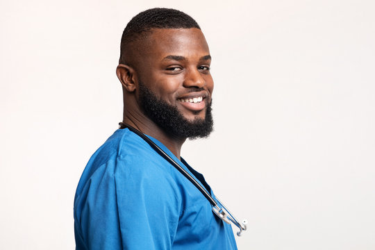 Profile Portrait Of African Young Doctor Over White Background