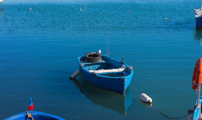 Boat moored on calm water of fishing harbor