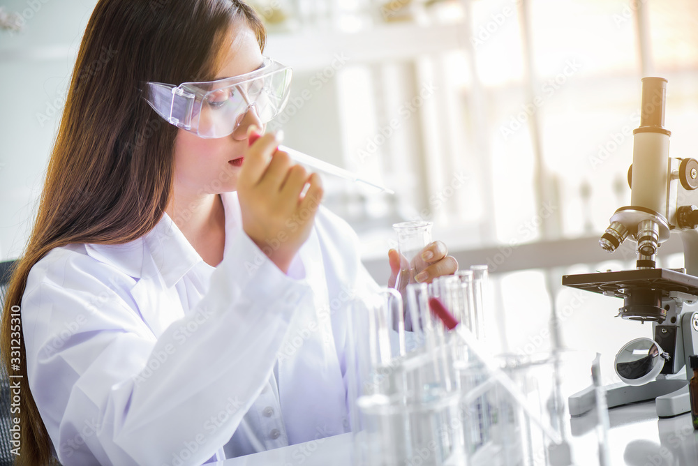 Canvas Prints attractive happiness scientist woman using microscope testing some blood sample at laboratory with l