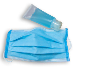 Blue face mask and hand sanitizer on a white background