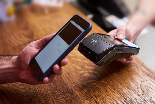 Customer paying by smartphone with NFC technology