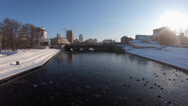 Ducks swim in Plotinka section of Iset River in snowy Yekaterinburg