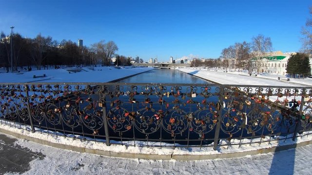 Padlocks on ornate iron Plotinka bridge in Yekaterinburg, Russia