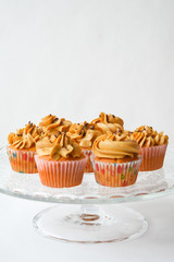 the bun with cream. delicious cupcake. delicious cake with air cream and nuts on a white background. home-made pastry.