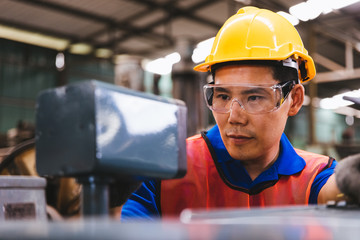 Industry factory maintenance engineer wearing uniform and safety helmet under inspection and...
