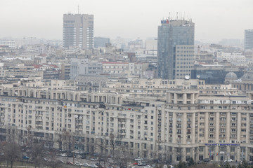 Overview of Bucharest as seen from the Palace of Parliament on a cloudy day.