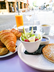 Breakfast with orange juice and fresh fruits on table