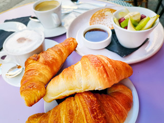 Breakfast with orange juice and fresh fruits on table