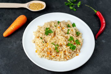 Bulgur with vegetables on a stone background. Healthy eating