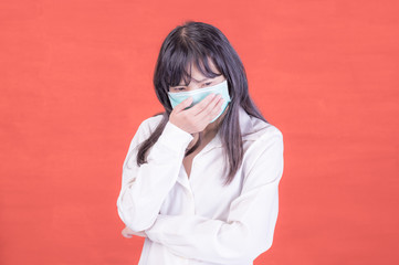 Asian business women have to use a mask to cover the face to prevent pollution from dust