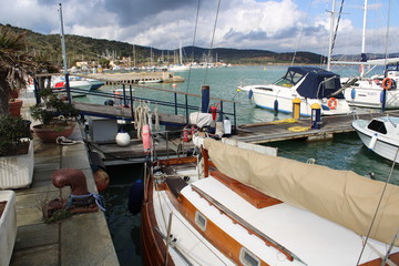A small boat in a harbor in the sunny winter day