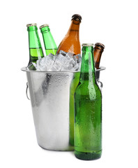 Metal bucket with bottles of beer and ice cubes isolated on white