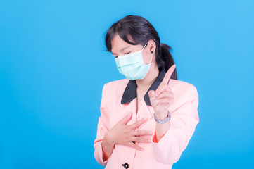 Asian business women have to use a mask to cover the face to prevent pollution from dust
