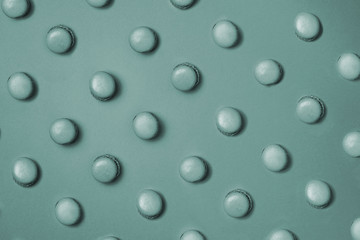 Green macaroons four types pattern on green background 