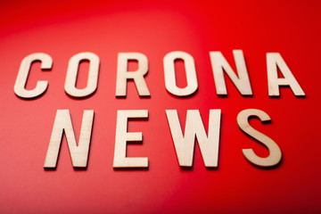 corona news word text wooden letter on red background coronavirus covid-19