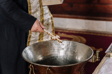 Priest perform  ritual Holy baptism christening