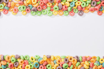 top view of bright multicolored breakfast cereal on white background