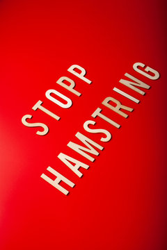 stopp hamstring norwegian word text wooden letter on red background coronavirus covid-19