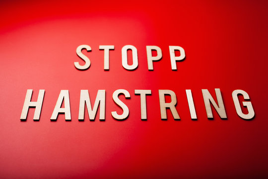stopp hamstring norwegian word text wooden letter on red background coronavirus covid-19