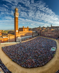 siena, piazza del campo full of people seen from the tower of palazzo sansedoni during the palio days - obrazy, fototapety, plakaty