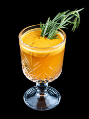 Hot drink with sea buckthorn and rosemary. On dark background