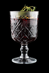 Hot mulled wine with thyme. On dark background