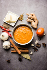 North Indian basic Curry for paneer butter masala or chicken makhanwala recipe shown with ingredients, served in a bowl. selective focus