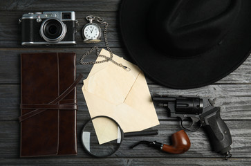 Flat lay composition with vintage detective items on grey wooden background